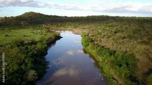 Aerial drone flight over river in uninhabited African nature wilderness
