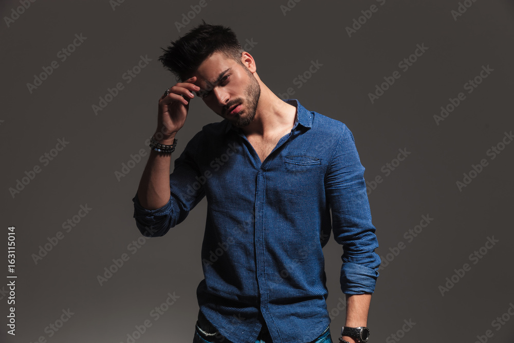 young pensive fashion man hold hand on forehead young pensive fashion man hold hand on forehead