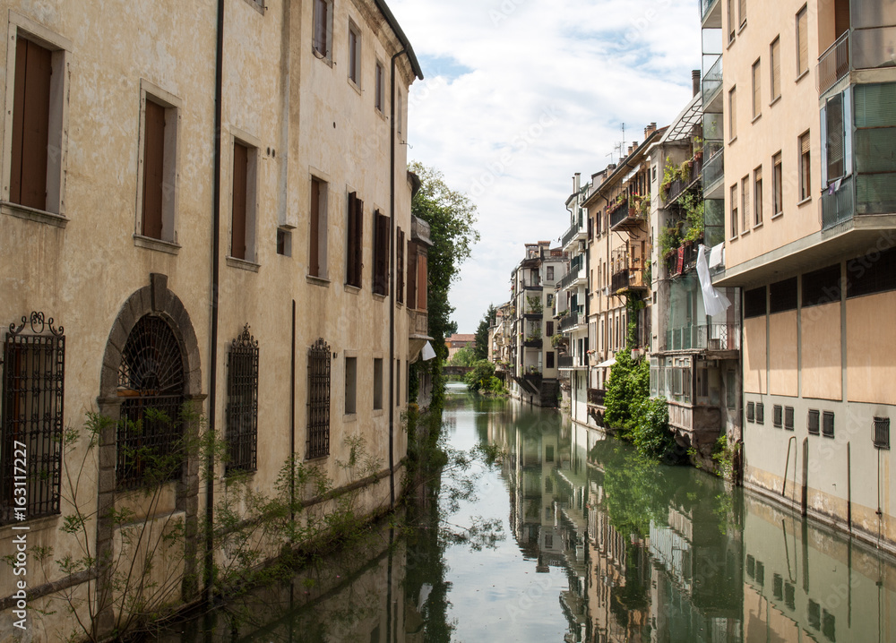 The city canal San Massimo runs among residential houses in the centre of the old city Padua, Veneto, Italy