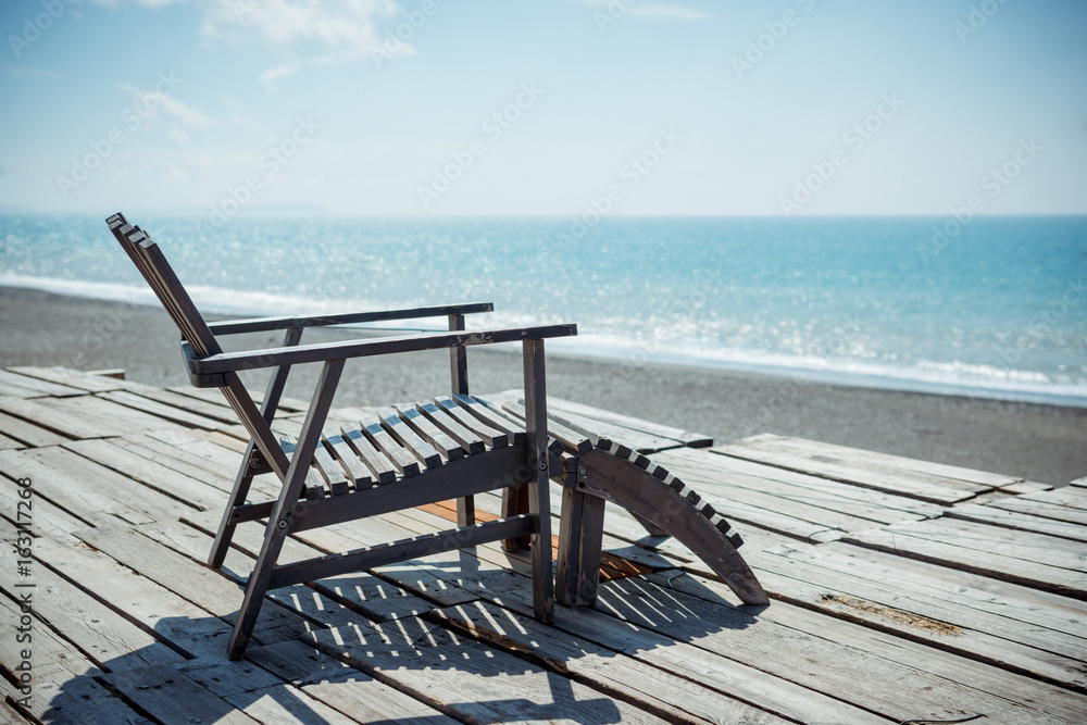 wooden chair on a beautiful tropical beach wooden chair on a beautiful tropical beach