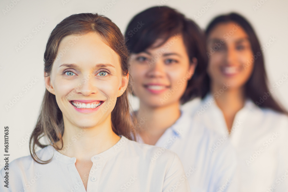 Portrait of happy young business team in row Portrait of happy young business team in row