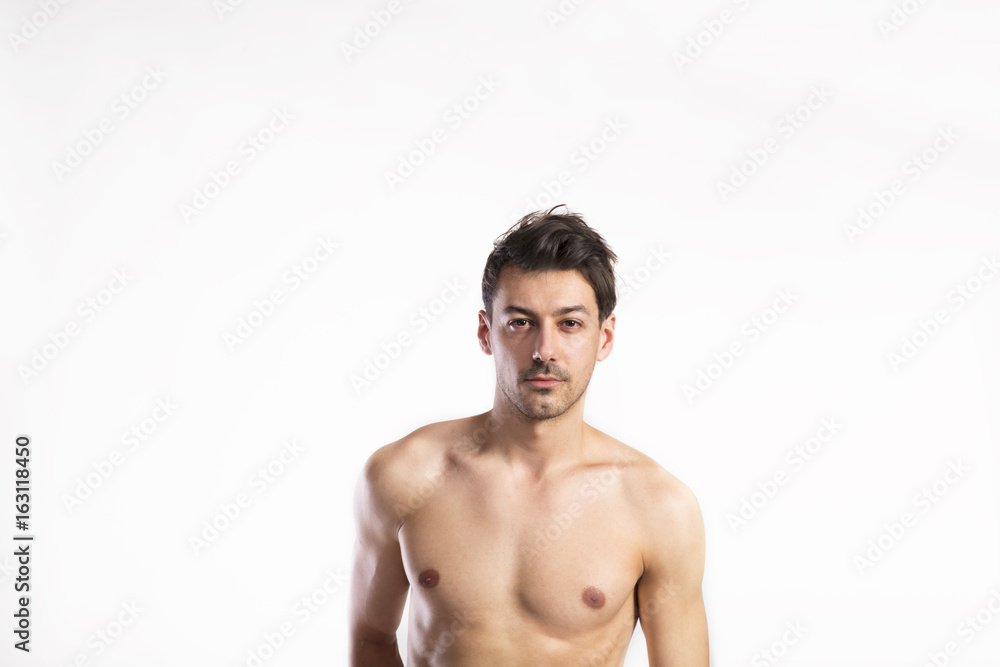 Shirtless fitness man. Studio shot. White background.