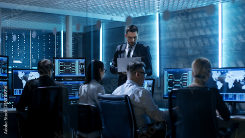 Obraz na plátně Professional IT Engineers Working in System Control Center Full of Monitors and Servers