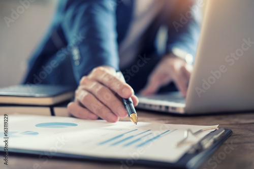 Business Man Studying accountant working with financial data Graph Report Concept