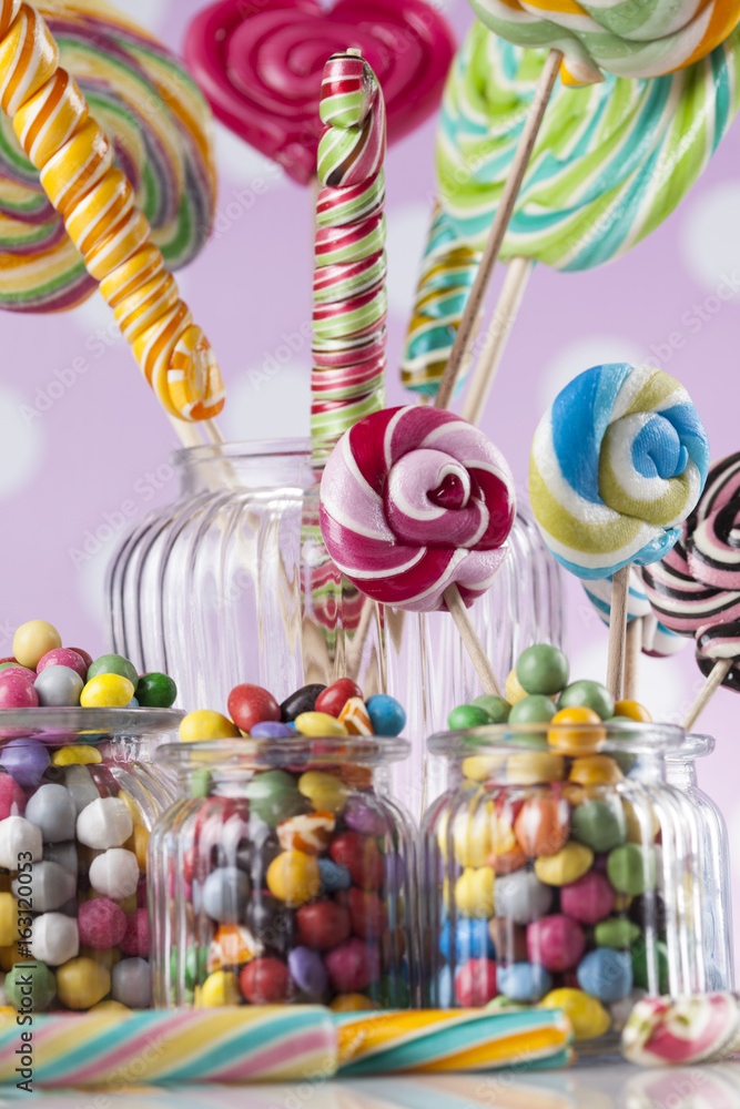 Fototapeta premium Colorful lollipops and different colored round candy and gum balls