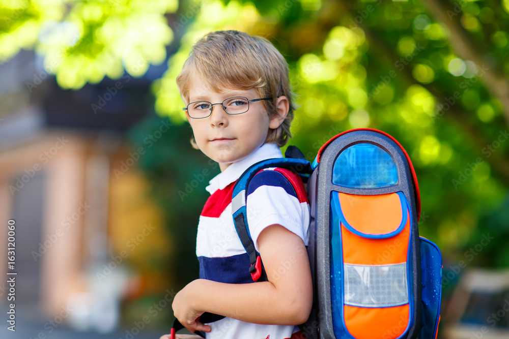 little kid boy with school satchel on first day to school little kid boy with school satchel on first day to school