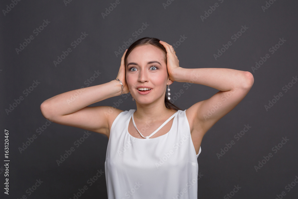 Fototapeta premium Shocked happy woman with touching her head