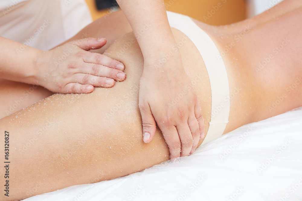 woman Getting a Salt Scrub Beauty Treatment in the Health Spa woman Getting a Salt Scrub Beauty Treatment in the Health Spa