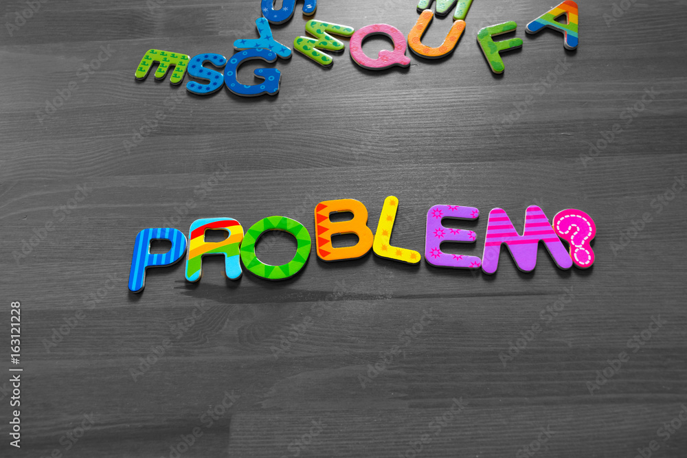 Question Problem? written in cheerful colorful letters from a magnet on a brown wooden table. Black and white. Concept of solving the problem. Ready to advert Question Problem? written in cheerful colorful letters from a magnet on a brown wooden table. Black and white. Concept of solving the problem. Ready to advert