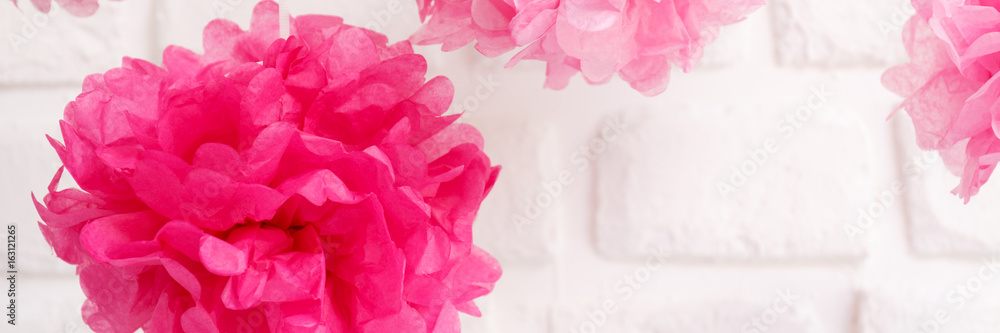 Fototapeta premium Paper flowers at the girl baby shower party. Baby shower celebration concept