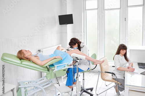 Photography Professional gynecologist examining her patient while the nurse is filling medical documents profession occupation job medicine hospital clinic gynecology healthcare