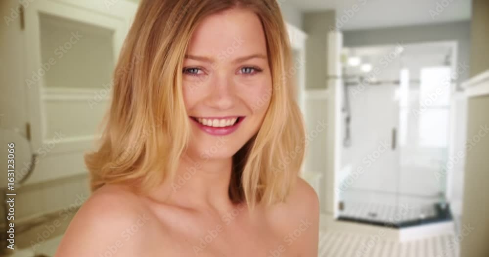 Portrait of laughing Caucasian woman showing bare shoulders on studio backdrop Portrait of laughing Caucasian woman showing bare shoulders on studio backdrop