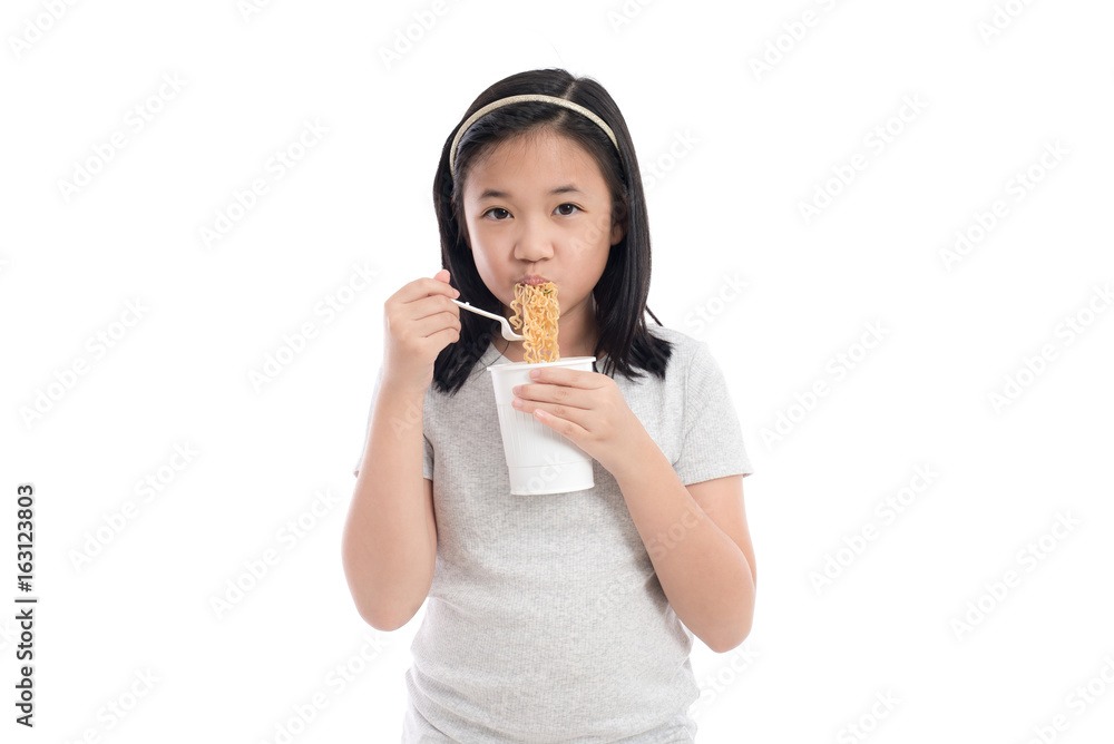 Beautiful asian girl eating instant noodle on white background isolated Beautiful asian girl eating instant noodle on white background isolated