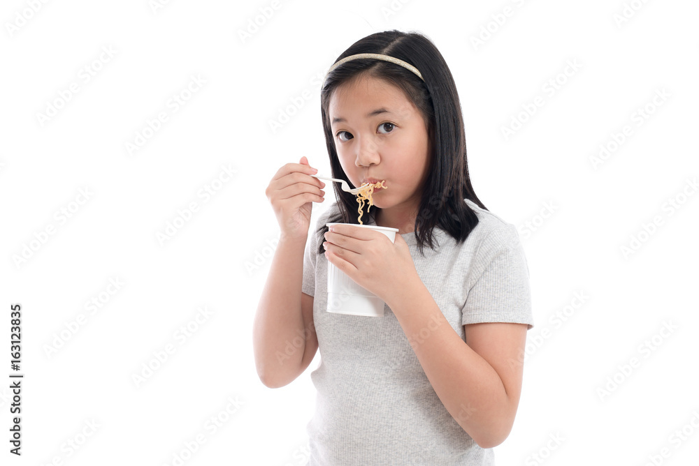 Beautiful asian girl eating instant noodle on white background isolated Beautiful asian girl eating instant noodle on white background isolated