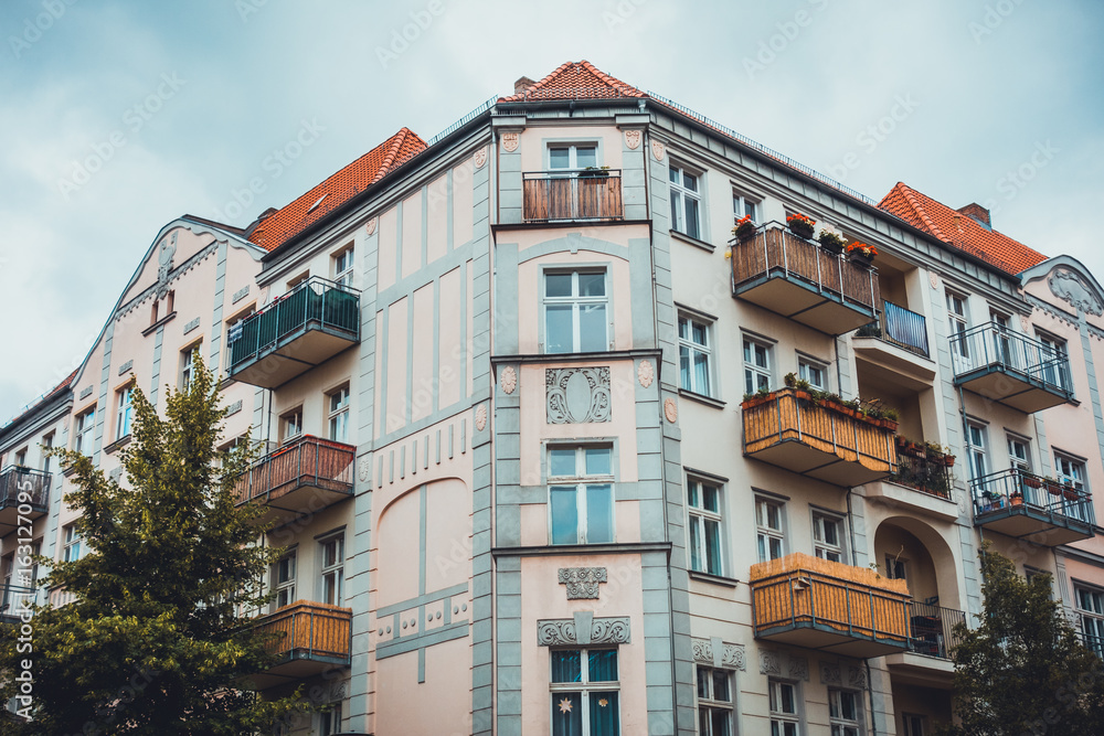 Obraz premium luxury corner house with balconies and red roof