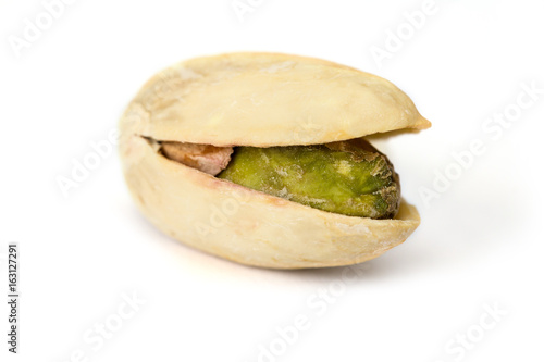 One pistachio nut cloe up isolated on white backgrond photo