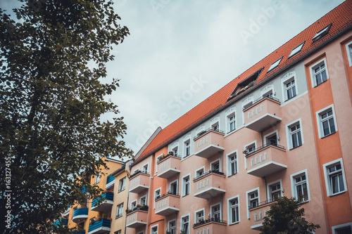 rose facaded building with balconies