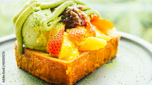 Sweet dessert bread toast with matcha ice cream and strawberry , orange