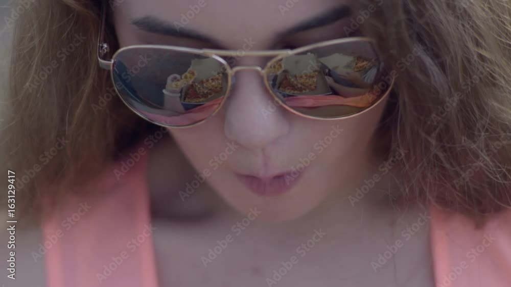Closeup Of Girls Sunglasses, Reflection Shows Pizza In Her Lap And Her Friend's Closeup Of Girls Sunglasses, Reflection Shows Pizza In Her Lap And Her Friend's