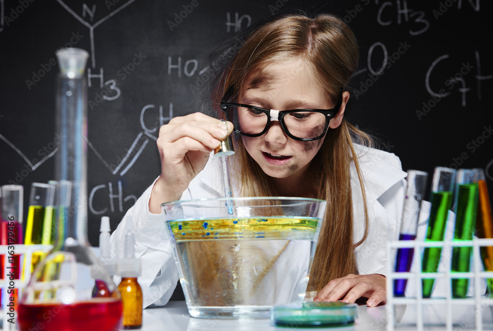 Young girl making a experiment in chemical laboratory Young girl making a experiment in chemical laboratory