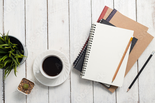 Empty notebook and coffee on  wooden table photo