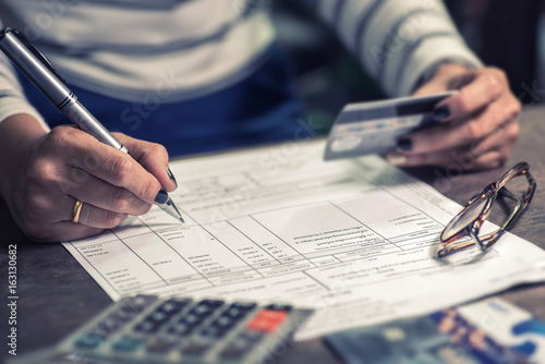 woman calculate how much cost or spending have with credit cards