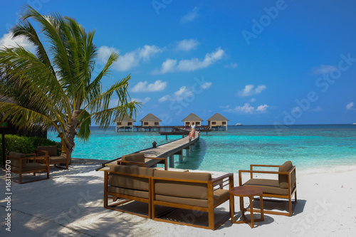 Enjoy, have a seat and relax in the water bungalows deck at the summer days. Maldive Islands.