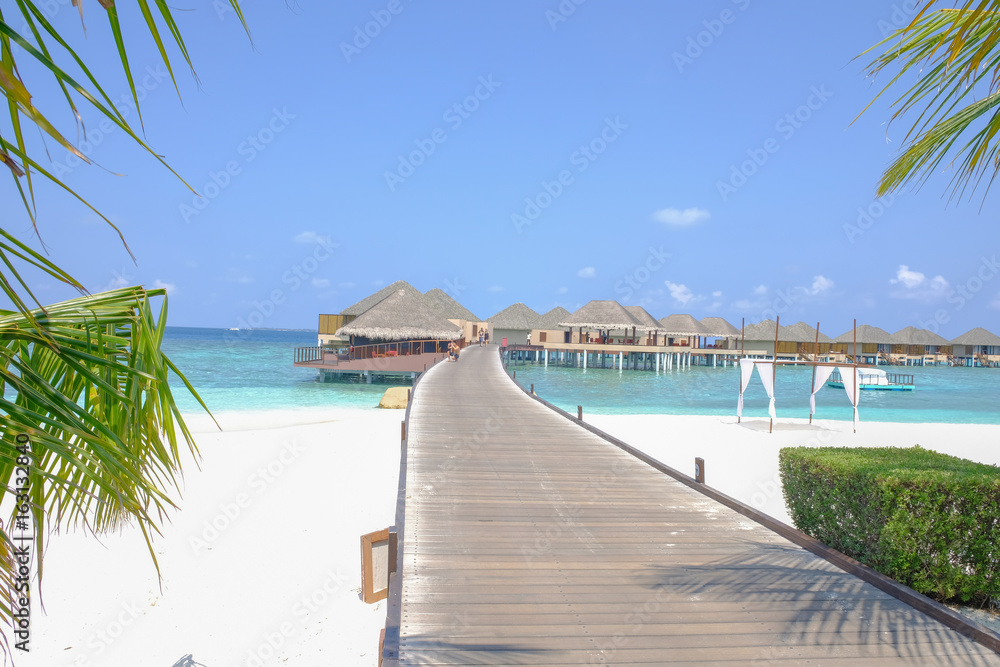 Wooden bridge on Sunny day in sea bungalow 