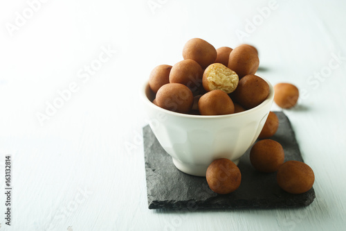 Sweet marzipan potatoes in white bowl photo