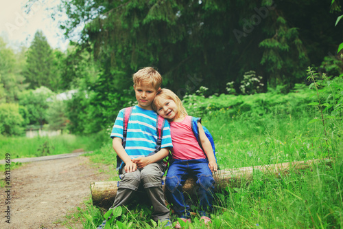 little girl and boy go hiking in nature