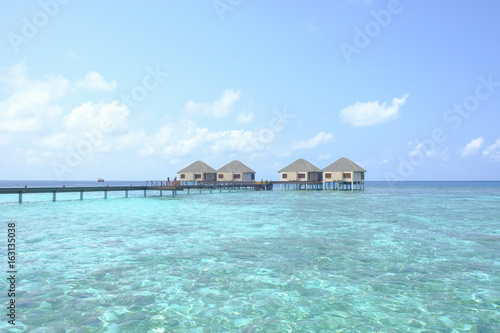 Beautiful dappled water surrounds the colony of water bungalows. Maldives Island. © isham