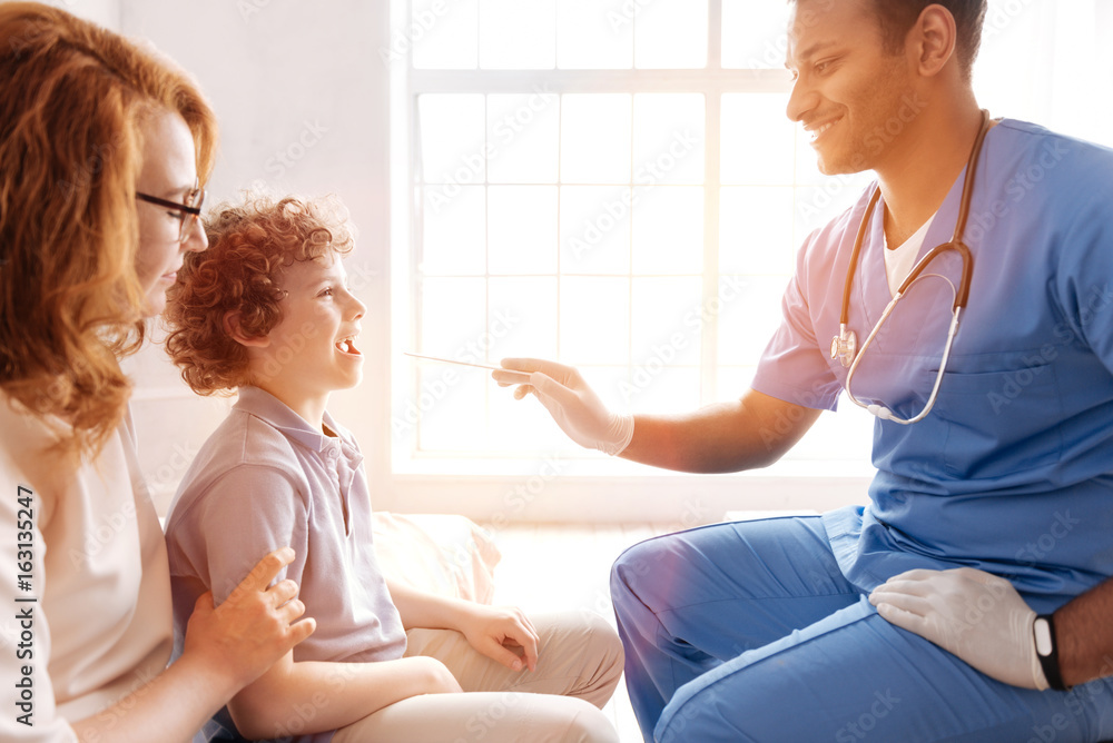 Profile photo of professional pediatrician while doing health examination Profile photo of professional pediatrician while doing health examination