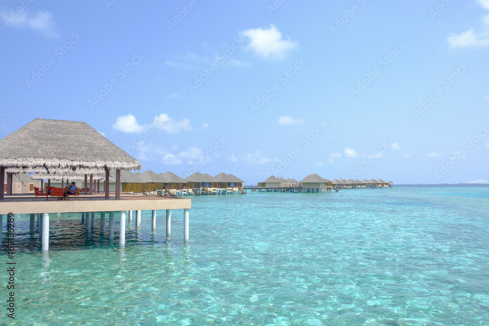 Beautiful dappled water surrounds the colony of water bungalows. Maldives Island.
