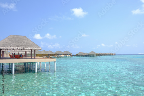Fototapeta Naklejka Na Ścianę i Meble -  Beautiful dappled water surrounds the colony of water bungalows. Maldives Island.