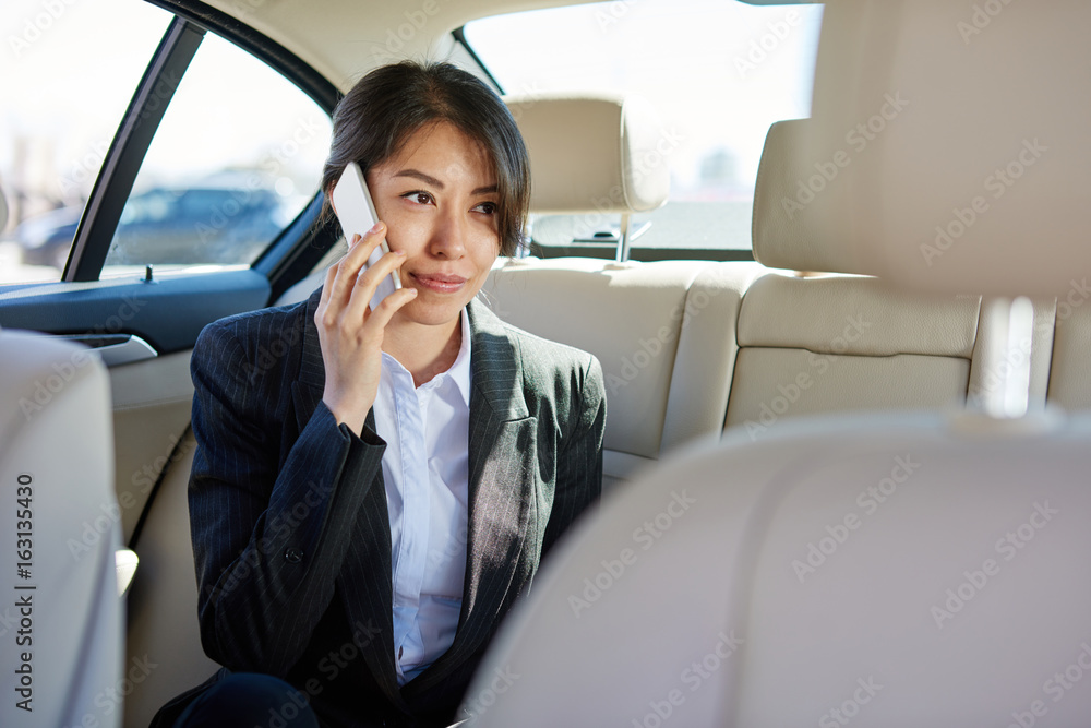 Business woman in suit talking by the phone in the car Business woman in suit talking by the phone in the car