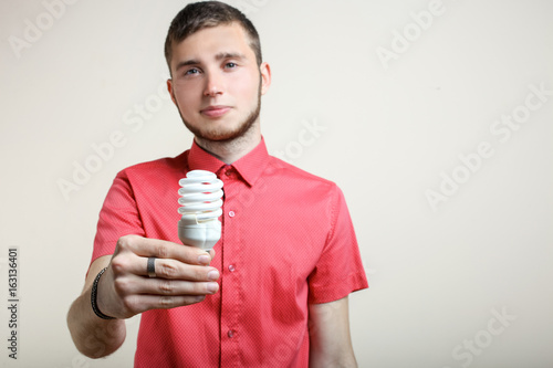 guy is holding a light bulb
