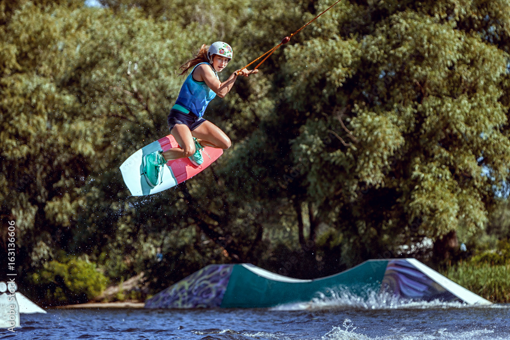 World champion in wakeboarding, she trains to jump.