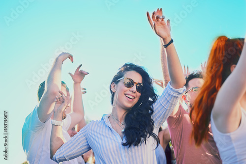 Obraz na plátně Caucasian girl dancing and having a good time at outdoor party
