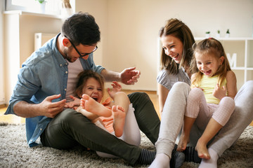 Cheerful family with two child spending time at home.