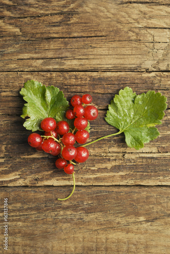 Red currant berries on a wooden background