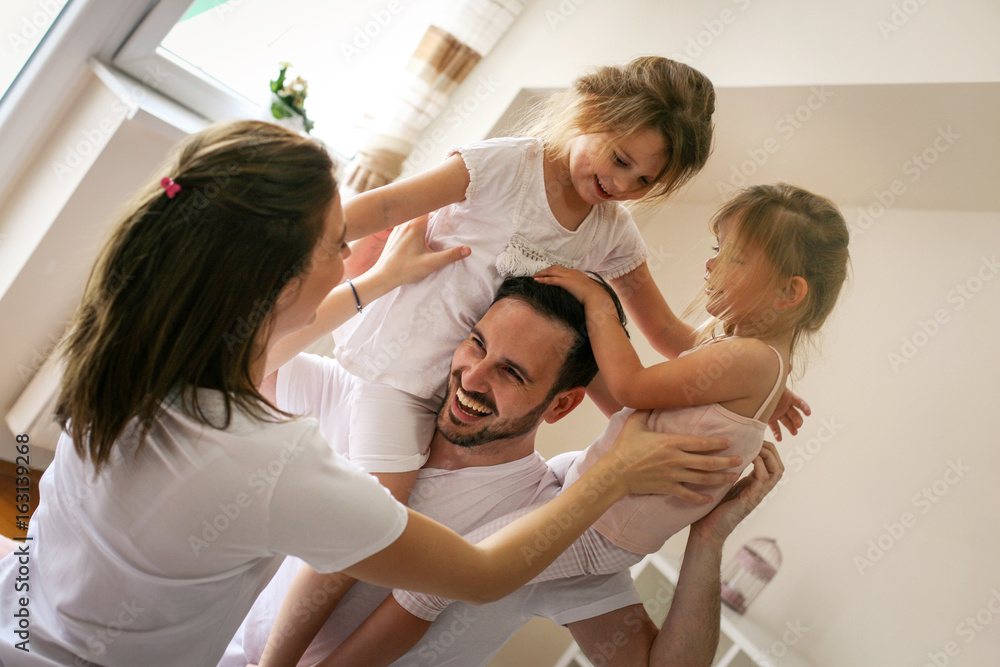 Fototapeta premium Happy family having fun on bed.