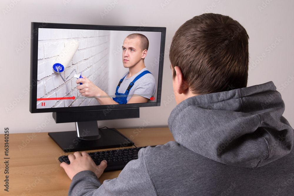 young man watching builder's video blog