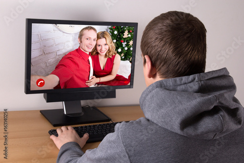 christmas concept - man videochatting with his friends