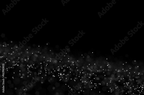 Falling dust cloud design . Particles cloud background, wallpaper with copy space. Rain, snow fall concept . Freeze motion of white powder coming down, isolated on black, dark background.