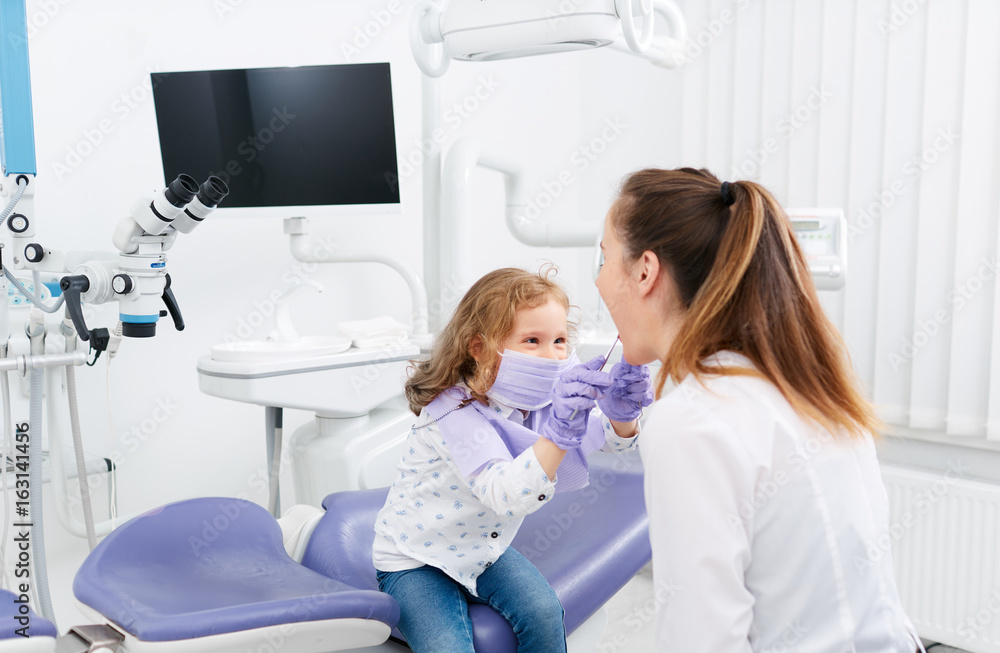 Little girl looking in dentist mouth Little girl looking in dentist mouth