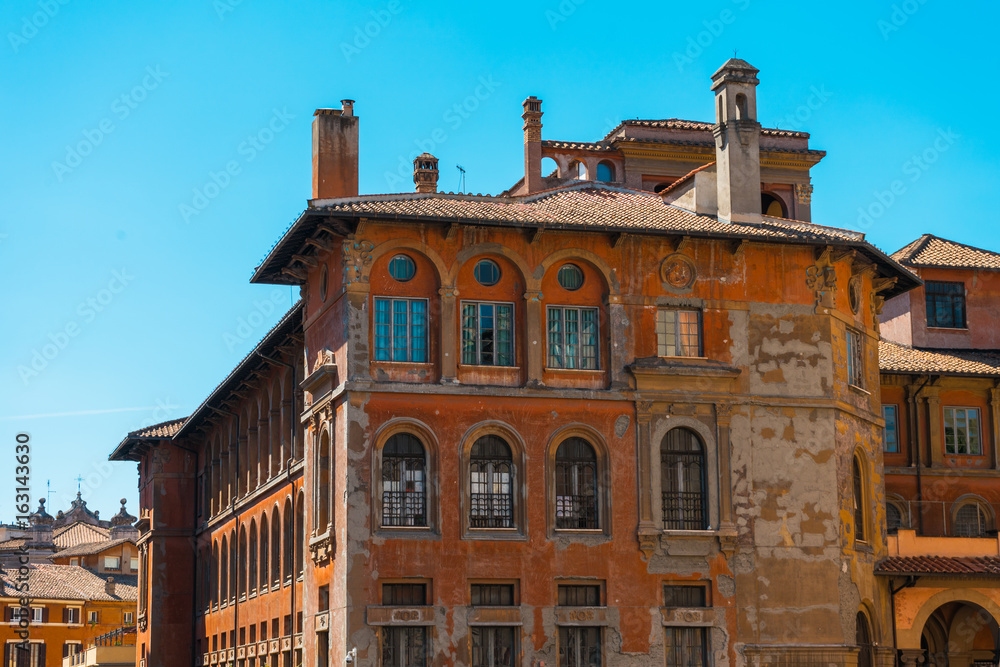 ancient apartment house with red facade at italy