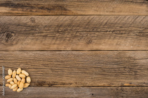 Peeled peanuts on an old wooden table.