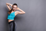 Beautiful fitness girl posing on studio background