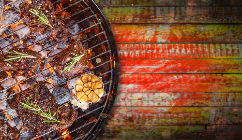 Barbecue grill with beef steaks, close-up.
