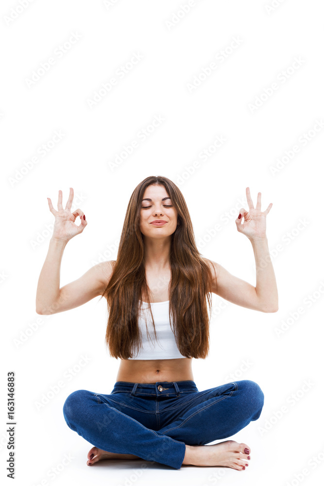 Beautiful young woman doing yoga over white background. Beautiful young woman doing yoga over white background.